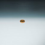 A minimalist Batman logo on a metallic roll-up door in daylight, Shilin District, Taipei.